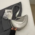 Metallic silver crescent shoulder bag with a modern minimalist texture and wide strap - Silver