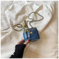 Mini blue denim crossbody bag with gold camellia charm and quilted diamond pattern - Blue (Solid Denim)