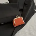 Vintage orange kiss-lock coin purse with litchi grain leather and gold metal clasp - Orange
