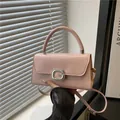 Roze minimalistische crossbodytas met handvat en sprankelende G-vormige sluiting - Roze