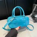 Glossy blue faux leather handbag with gold hardware and adjustable strap for women - Blue