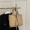 Beige quilted dumpling handbag featuring heart pattern embroidery and drawstring closure - Khaki