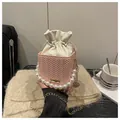 Détail du sac seau rose tressé avec grande poignée en perles et chaîne dorée - Rose