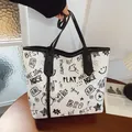 White large-capacity tote bag featuring black graffiti print and sleek black shoulder straps - Black