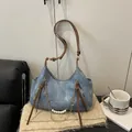 Blue denim tote bag with brown faux leather strap and decorative faux pearl chain detail - Blue