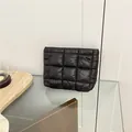 Minimalist black quilted puffer clutch bag in waterproof nylon with a chic padded finish - Black