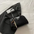 Glossy black bowling bag with wooden bead charm and long shoulder straps for women - With Pendant / Black