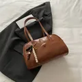 Brown retro PU leather bowling handbag with wooden bead charm and long dual handles - With Pendant / Brown