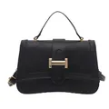 Quilted black crossbody bag with crescent base and gold buckle on white background - Black