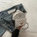 Polka dot mini backpack with cat graphic, chain strap, and metal twist lock closure - Black