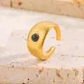 Détail d'une bague en acier doré 18k avec pierre noire et motif soleil rayonnant - Émail Noir / Or