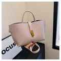 Light pink pebbled leather tote bag with elegant golden turn-lock and top handle strap - Dusty Pink