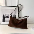 Dark brown matte suede pillow bag with adjustable shoulder strap and debossed logo - Brown