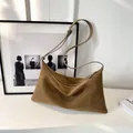 Minimalist brown suede leather shoulder bag in a triangular shape with adjustable strap - Khaki