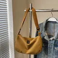Ginger yellow corduroy crossbody dumpling bag with wide shoulder strap and dual zippers - Brown