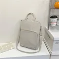 Minimalist beige oxford fabric crossbody laptop bag with front zipper pocket and top handles - Off White