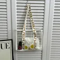 Transparent PVC tote with white daisy inner bag and patterned wide shoulder strap - White
