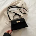 Black crinkled crossbody bag with golden twist lock and adjustable shoulder strap - Black