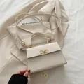 Minimalist beige crossbody bag with gold twist lock and top handle in matte leather - White