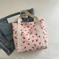 Pink corduroy tote bag with strawberry print and white canvas handles for daily use - Pink