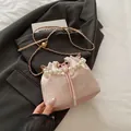 Champagne pink jacquard bucket bag with pearl handle and metal chain strap - Pink