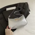 Silver metallic PU leather underarm bag with a golden bow buckle and dual-tone strap - Silver