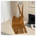 Detailed view of caramel suede shoulder bag featuring long fringe and bohemian design - Khaki