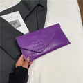 Deep purple envelope clutch bag featuring glossy crocodile embossed pattern on a suit jacket - Purple