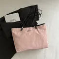 Light pink tote bag with crinkled texture, black long straps and small metal logo charm - Pink Without Pendant
