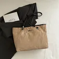 Minimalist beige tote bag with crinkle texture and black shoulder straps on a blazer - Khaki (No Pendant)