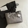 Metallic silver pleated tote bag with black handles and cute plush charm pendant - Grey With Pendant