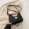 Elegant black crescent hobo bag with gold hardware and adjustable strap in minimalist style - Black