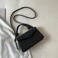 Minimalist black woven flap crossbody bag in PU leather with V-pattern texture - Black
