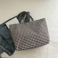 Brown and white gingham canvas tote bag in a casual lifestyle layout with denim - Black