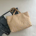 Yellow and white gingham canvas tote bag with dual straps on denim background - Yellow