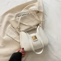 Elegant cream crescent crossbody bag featuring a golden square rivet buckle design - White