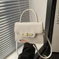 Chic cream leather handbag with lizard pattern flap and elegant gold metal lock clasp - White