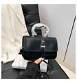 Black leather crossbody bag with silver sculpted handle and heart metallic buckle - Black
