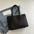 Minimalist black large capacity tote bag in sleek nylon fabric with double handles - Black