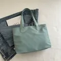 Minimalist light green tote bag made of smooth nylon fabric for daily office commuting - Green