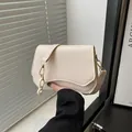 Creamy white chic shoulder bag with wavy flap and metallic chain detail for women - White