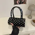 Mini cylindrical Boston bag with black and white polka dots in high-gloss patent finish - Black