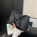 Classic black woven shoulder bag with intricate leather craftsmanship and minimalist style - Black