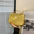 Golden crocodile pattern hobo bag with butterfly ornament and metallic handle - Gold