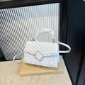 White quilted crossbody bag with pleated handle and golden square clasp closure - White