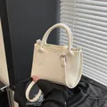 Chic beige lychee textured bucket bag with dual handles and silver buckle details - Basic Style / White
