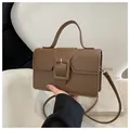 Deep brown matte leather handbag with large decorative square buckle and shoulder strap - Brown