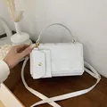 Quilted white crossbody bag with gold hardware and a detachable small pouch - White
