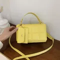 Yellow quilted crossbody square bag with top handle and matching mini coin purse detail - Yellow