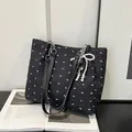 Fashionable black tote bag with bow print, silver chain, and pearl butterfly charm - Black With Pendant